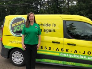 Office manager Rochelle Woodson in front of Mosquito Joe van